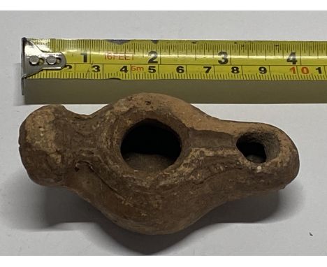 A antique Byzantine 6th century crossed back clay oil lamp.