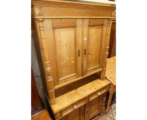A 19th century provincial French pine buffet side cupboard, having an arrangement of four cupboard doors and twin frieze draw