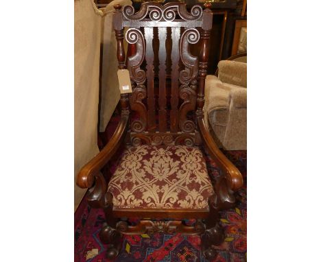 An early 20th century walnut framed splat back scroll elbow chair, in the early Georgian taste, with tapestry woven inset sea