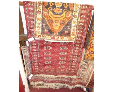 A Persian woollen cream ground Bokhara rug, with multiple trailing tramline borders, together with a Persian woollen red grou