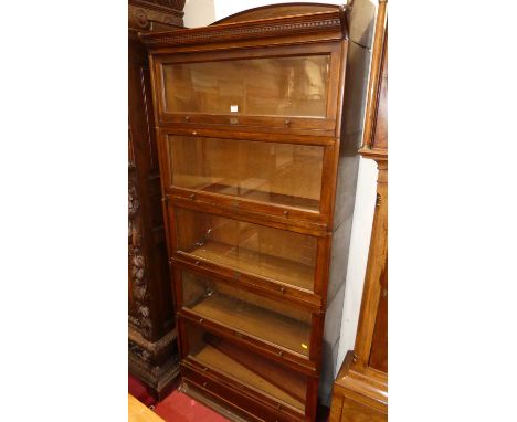 A 1930s beech five-tier stacking bookcase by the Lebus Bookcase Company, having typical hinged glazed doors and single long l