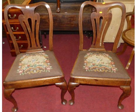 A set of four 19th century mahogany pierced splat back dining chairs, each having floral needlework tapestry upholstered drop