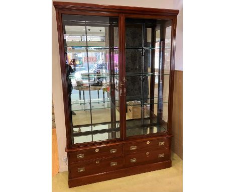 An Edwardian mahogany double door shop display cabinet, attributed to E. Pollard & Co, the glazed doors enclosing four heavy 