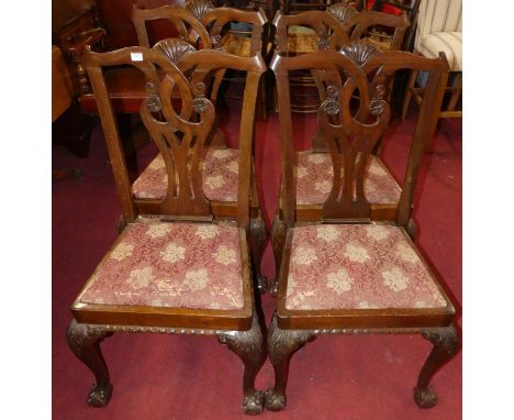 A set of four mahogany Chippendale style dining chairs, each with red floral embroidered fabric drop-in pad seats and raised 