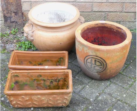 A pair of terracotta small trough planters, together with two further terracotta circular planters, and a model hedgehog (5)