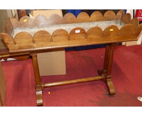 An early Victorian mahogany trough planter, with removable zinc liner, arched and teardrop detailed upper edge, raised on twi