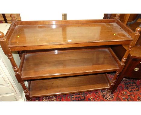 A mahogany three-tier buffet, raised on ring turned supports, width 119cm