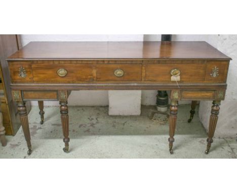 SIDE TABLE, Regency mahogany and gilt metal mounted, with three drawers and ebonised reeded supports, 87cm H x 168cm x 64cm. 