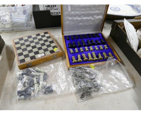 Two boxed chess sets with extra chess pieces