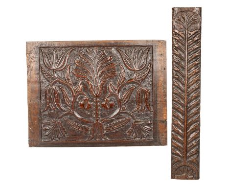 TWO CARVED OAK PANELS comprising a rectangular panel centrally carved with scrolling foliage, the other elongated rectangle i