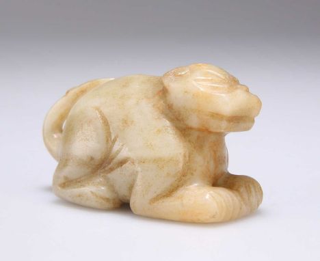 A CHINESE JADE CARVING depicting a recumbent lion dog. 7.8cm long, 4.4cm high