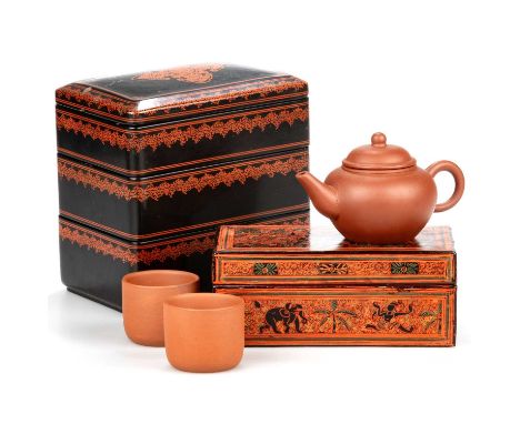 A BURMESE RECTANGULAR RED LACQUER BOX painted with figures and elephants, 17cm wide; a Burmese three-tier black and red lacqu