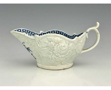 A Worcester relief moulded sauce boat, circa 1765, the interior decorated in blue and white with the Sauceboat Peony Pattern,