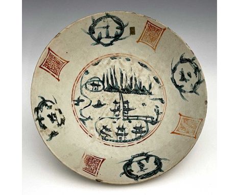 A Chinese famille verte dish, Ming, circular form, painted with a central landscape within an iron red seal and foliate carto