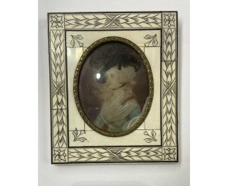 An 18th century portrait miniature painted to depict a young bewigged woman with black ostrich feather hat, on ivory, 6.4 by 