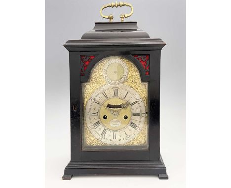 John Clark, London, a George II ebonised bracket clock, caddy top with a brass swing handle, arched brass dial with a subsidi