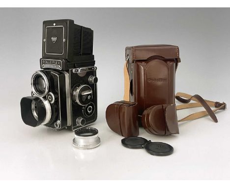 A Rollei Rolleiflex 2.8F camera, Franke &amp; Heidecke, DBP Serial No. 2434078, in an outer protective case with spare lens