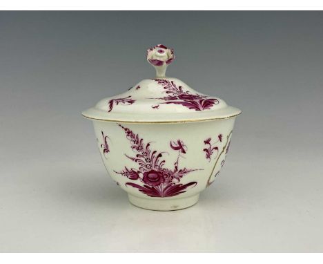 A Worcester sucriere and cover, circa 1765, painted in the Meissen style with puce floral decoration within gilt Rococo carto