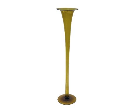 A large Arts and Crafts glass floor standing lily vase, footed trumpet form, green amber, 106cm high