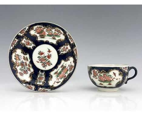 A Worcester scale blue cup and saucer, square seal mark, circa 1770, painted with chrysanthemums in the Rich Kakiemon pattern