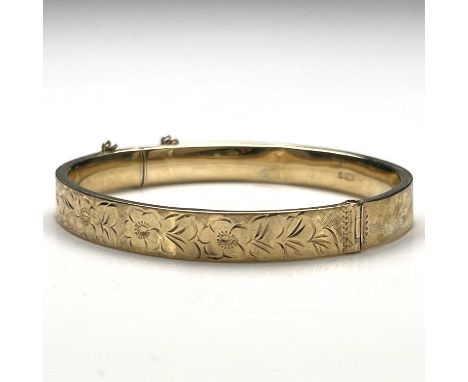 A Victorian 9 carat gold bangle, Birmingham 1899, chased floral decoration, 6.5cm diameter, 10.5g