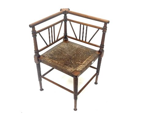An Aesthetic Movement Thebes corner chair, Oetzman and Co., circa 1880, the square rush seat on bobbin turned and tapered mus