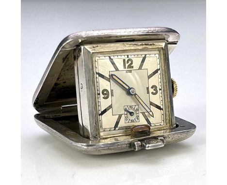 An Art Deco silver cased travel watch, Sapho Swiss movement square dial with subsidiary seconds dial, engine turned cushion f