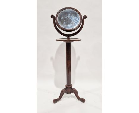 19th century mahogany shaving stand, the moulded framed swing circular mirror held on a carved scrolling frame, with circular