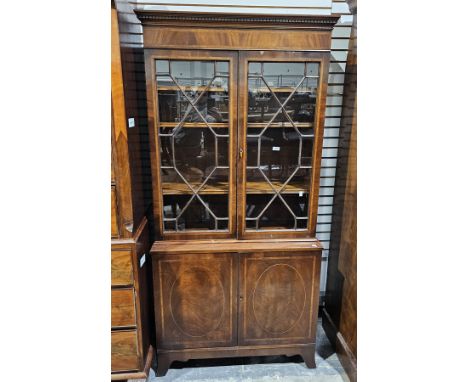 20th century mahogany and cross-banded library bookcase&nbsp;in the Georgian manner, the upper section with dentil cornice, t