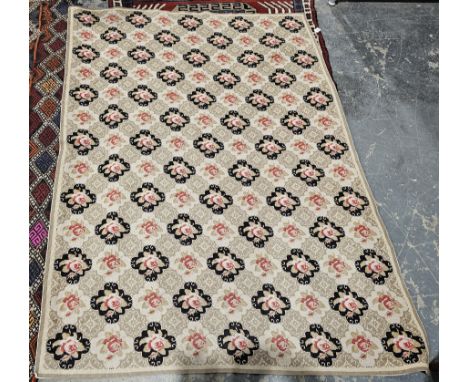 Hand stitched wool work tapestry with a pattern of rows of roses on alternating cream and black panels, 180cm x 130cm