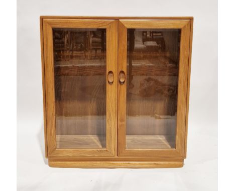 Ercol pale blonde elm windsor glazed bookcase/display cabinet, model 810, with two glazed doors opening to two adjustable she