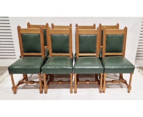 Set of eight Stroud Furniture Makers pale oak dining chairs, the backs with thumbnail carving and green leather upholstered s