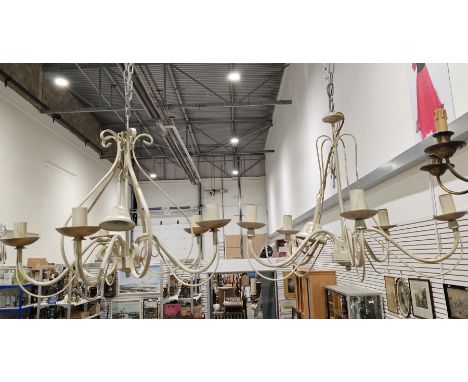 Two contemporary cream and gilt metal five-light chandeliers, each with scroll-shaped branches, suspended from a chain, one 4
