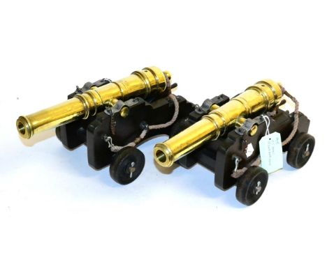 A Pair of Model Ship Cannons, 1:5 scale, modern, each with a brass five-ring barrel, 35.5 cm long, carved oak carriage with c