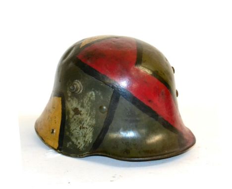An Imperial German M16 Army Helmet, with later camouflage paint, with three part padded leather liner, lacks chinstrap