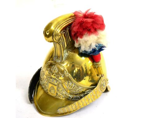 An Early 20th Century French Fireman's Brass Helmet, with high fluted comb, embossed front plate with the legend SRS POMPIEUR