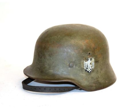 A German Third Reich M35 Army Helmet, with traces of later single decal, the left inner brim stamped EF.66, the back stamped 