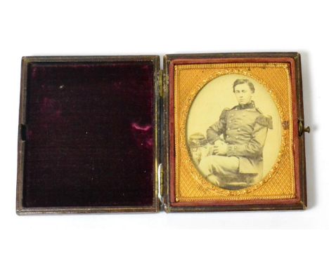 A Rare U.S. Civil War Period Photograph of a U.S. Marine, seated three quarter length, wearing a coattee with scaled and frin