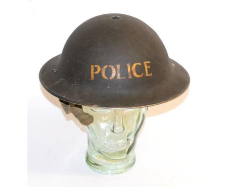 A Second World War Brodie Helmet to the Police, with black oil cloth liner, the liner straps stamped 7 VERO I 1938, with elas