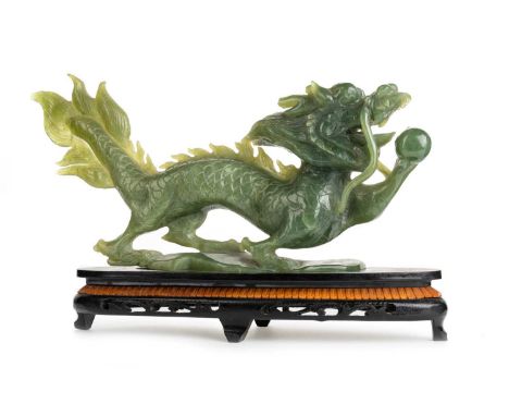 CHINESE JADE FIGURE, 20TH CENTURY modelled as a dragon holding the flaming pearl, on wooden stand38cm longIn overall fair con