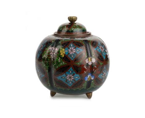 JAPANESE CLOISONNE LIDDED JAR, LATE 19TH / EARLY 20TH CENTURY of lobed form and decorated with flowers, raised on tripod feet