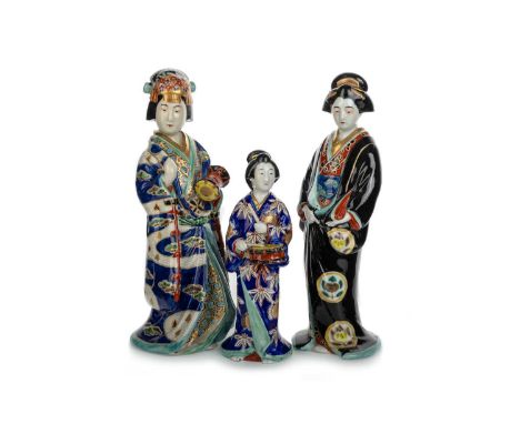 THREE JAPANESE CERAMIC GEISHA FIGURES, ALONG WITH A HARDSTONE GEISHA FIGURE each modelled in traditional Japanese dress while