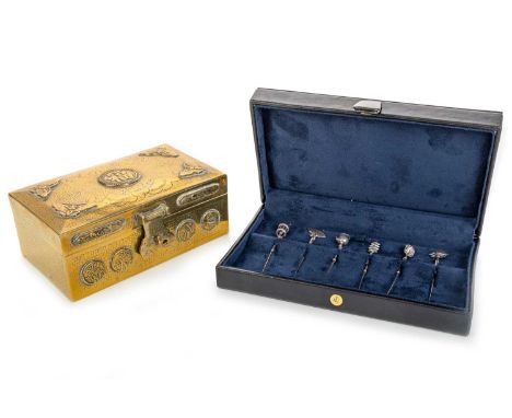 SET OF SIX CHINESE SILVER COCKTAIL STICKS, ALONG WITH A CHINESE BRASS CIGARETTE CASKET,  the cocktail sticks each with a diff