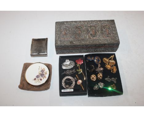 Two boxes containing cuff-links, ear-rings and brooches; and an ornate figural decorated box containing travelling clock and 