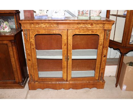 A 19th Century walnut and marquetry inlaid china display cabinet, the interior shelf enclosed by a pair of arched glazed pane