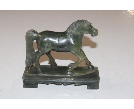 A Nephrite jade coloured carving in the form of a horse 