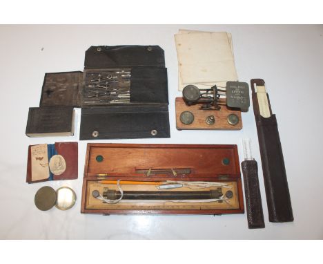 A set of wooden and brass postage scales and weights; a brass cased compass; drawing instruments; rolling ruler etc. 