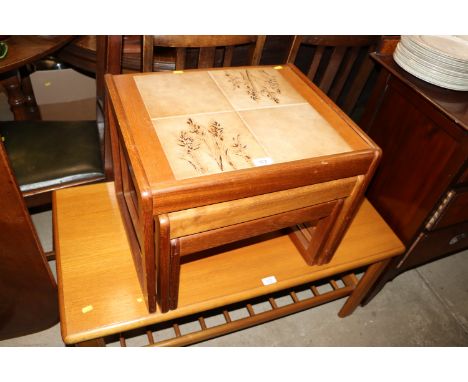 A nest of three teak and tile top occasional tables 