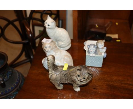 Two Beswick cat ornaments; and two Nao kitten ornaments 