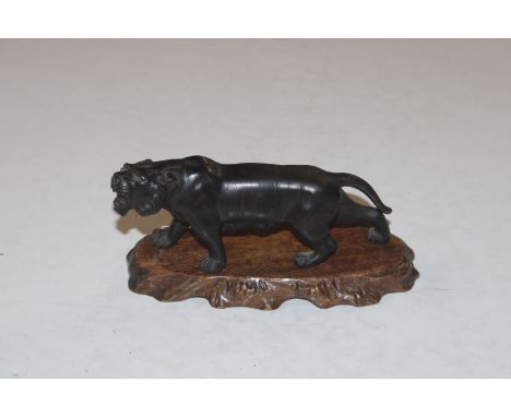A bronze model of a tiger, marked to base raised on wooden plinth